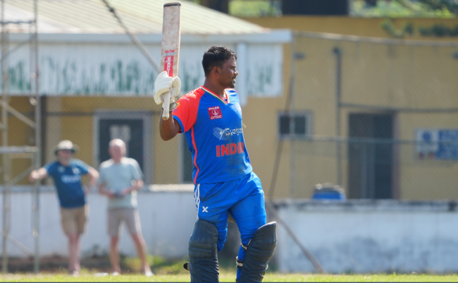 A cricket batter playing a shot